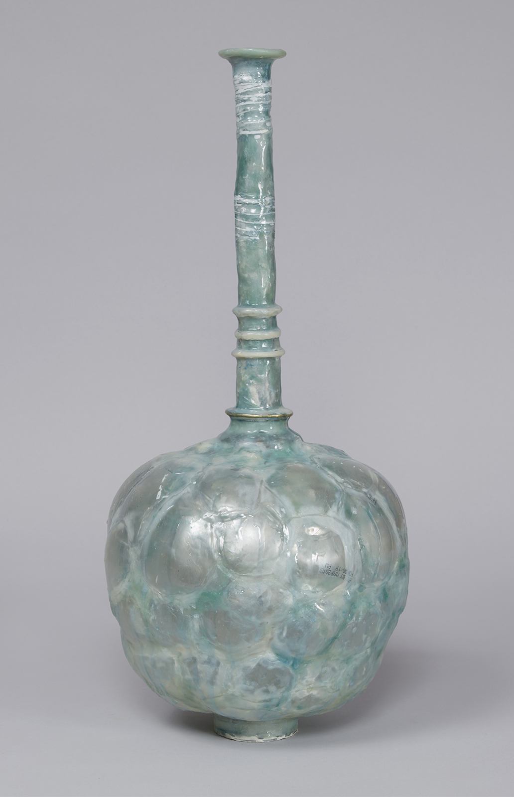 Vessel with long neck and brass ring